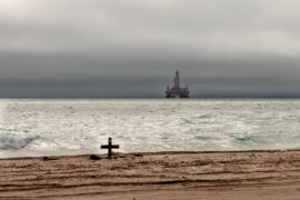 An oil rig looms amid threatening skies over the Atlantic Ocean off the coast of Namibia.