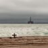 An oil rig looms amid threatening skies over the Atlantic Ocean off the coast of Namibia.