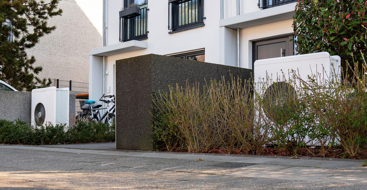 Heat pumps in the front garden of terraced houses in Duesseldorf, Germany. Image ID: 2WR3BD8.