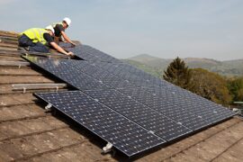 Fitting solar pv panels to house roof Wales UK.