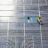 Worker examines solar panel.