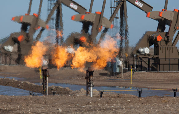 Natural gas is flared off as oil is pumped in the Bakken shale formation. Credit: Jim West / Alamy Stock Photo E1MT0N