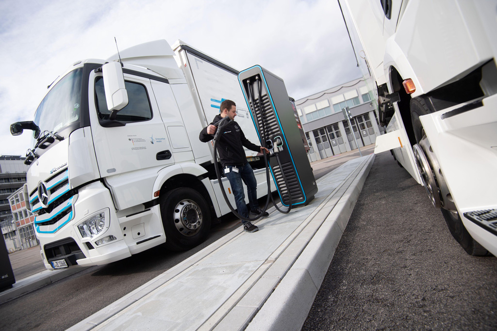 Electrically powered truck being charged