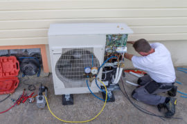 Plumber installing a heat pump.